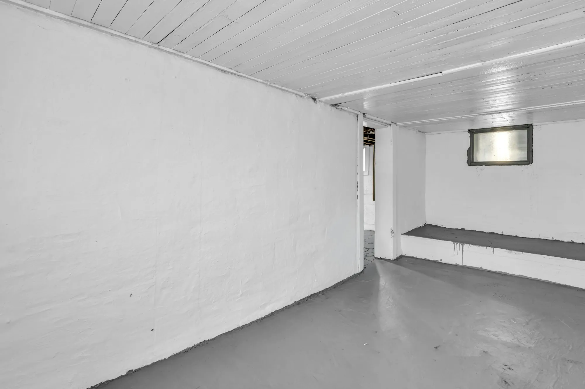 Basement media room with carpet, recessed lights and a built-in shelf wall