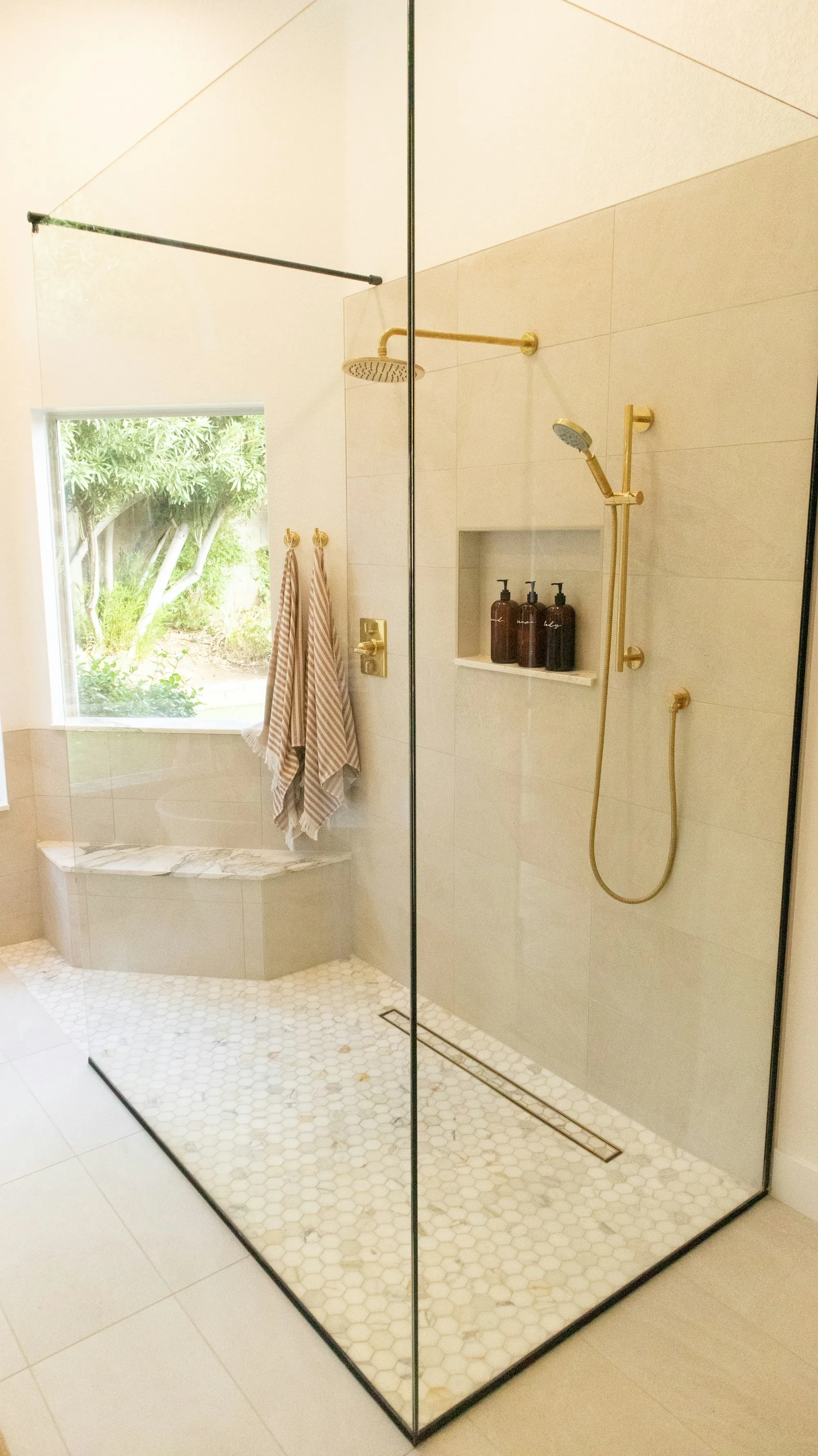 Hall bathroom with white subway tile, a new vanity and a framed mirror