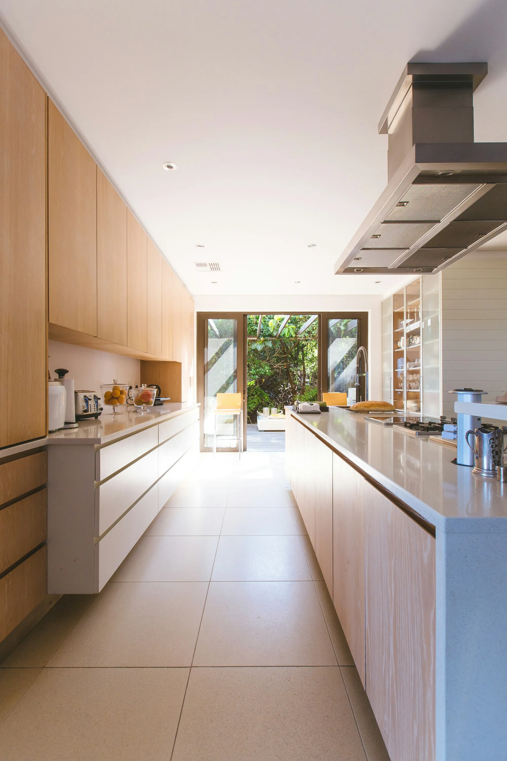Kitchen with white cabinets, a farmhouse sink and pendant lights over the island